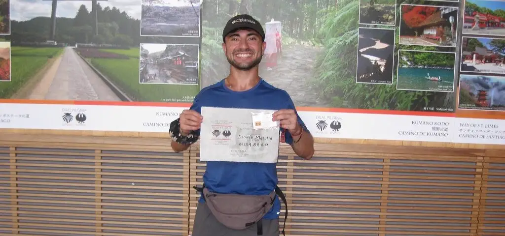 Holding the Dual Pilgrim certificate at Kumano Hongu Taisha